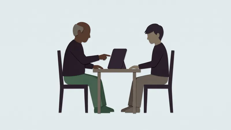 Two people at a small table sharing one tablet; one points at the screen. Cut-paper illustration.