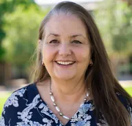Professor Elizabeth Kendall, smiling outdoors.