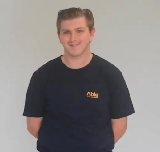 Cody in an Able t-shirt, smiling.