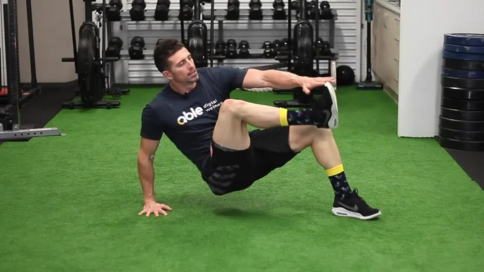 A coach demonstrating an exercise in the gym, from an Able video.